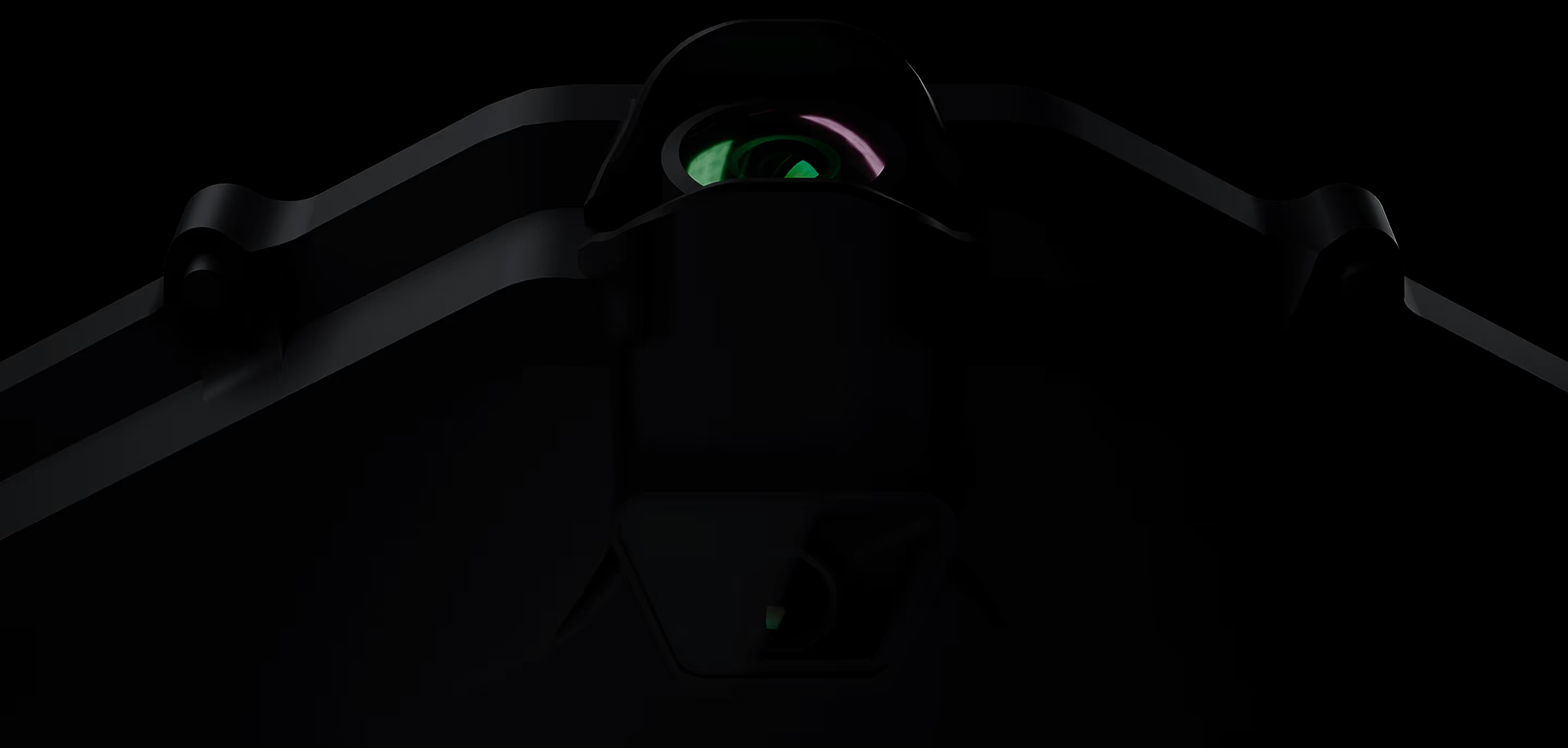 A heavily blurred image of a drone silhouette against a mountainous landscape at dusk.